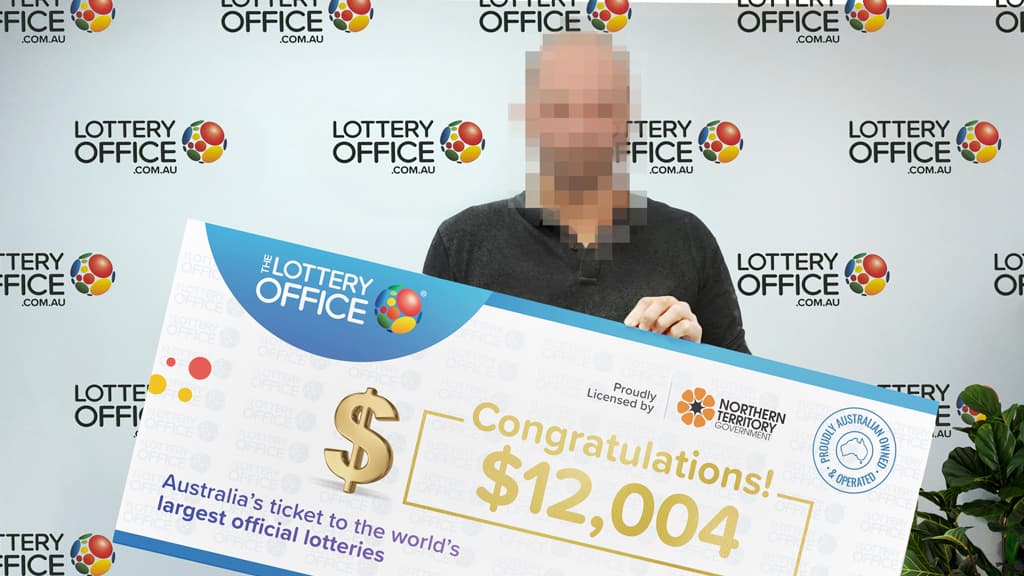 Man holding winning cheque.