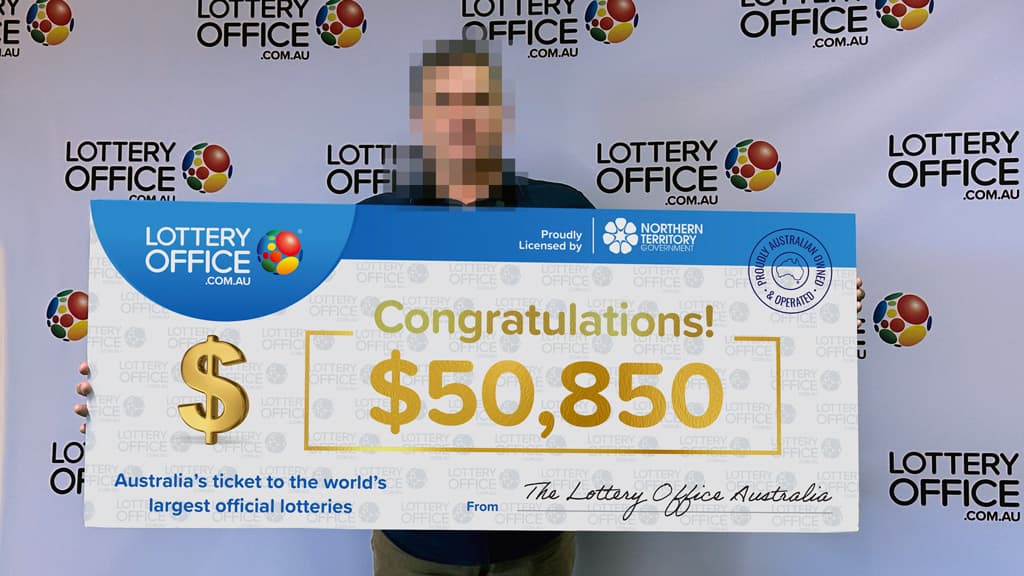 Winner holding giant cheque.