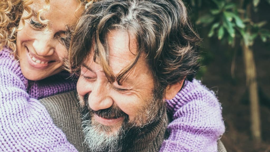 Close up portrait of joyful caucasian couple hugging