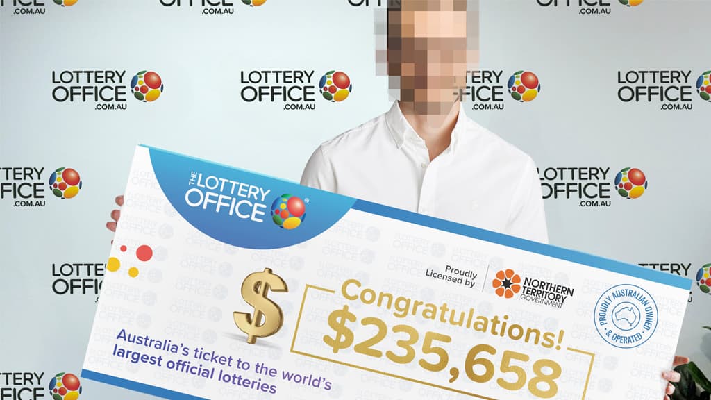 Man holding a winning cheque.