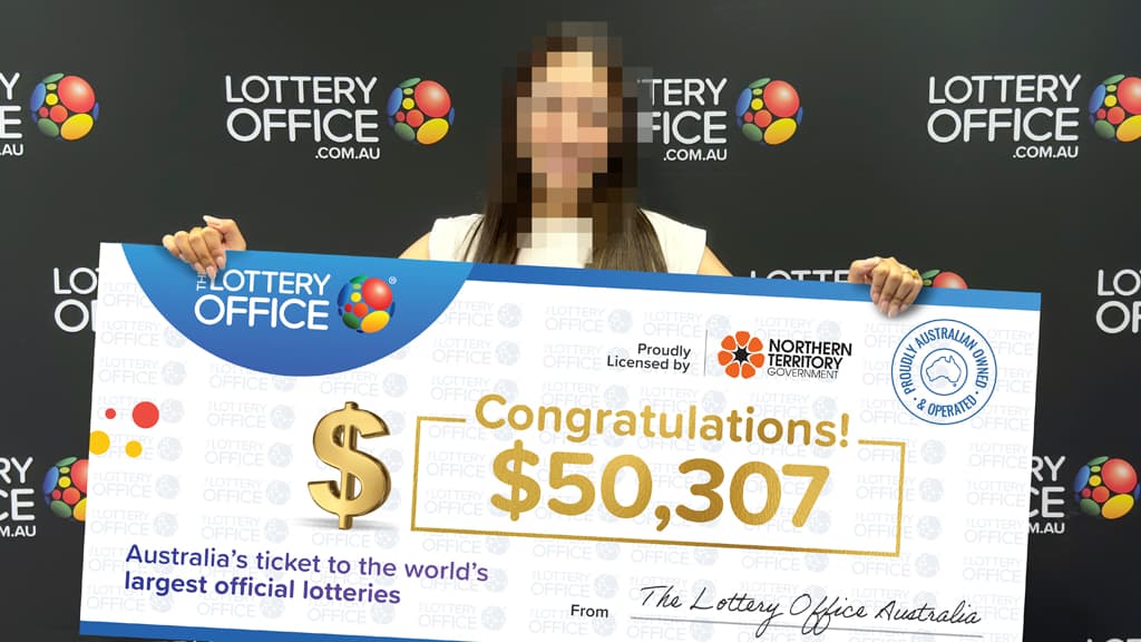 Woman holding winning cheque.