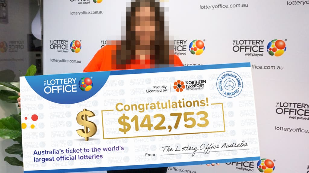 Woman holding cheque.