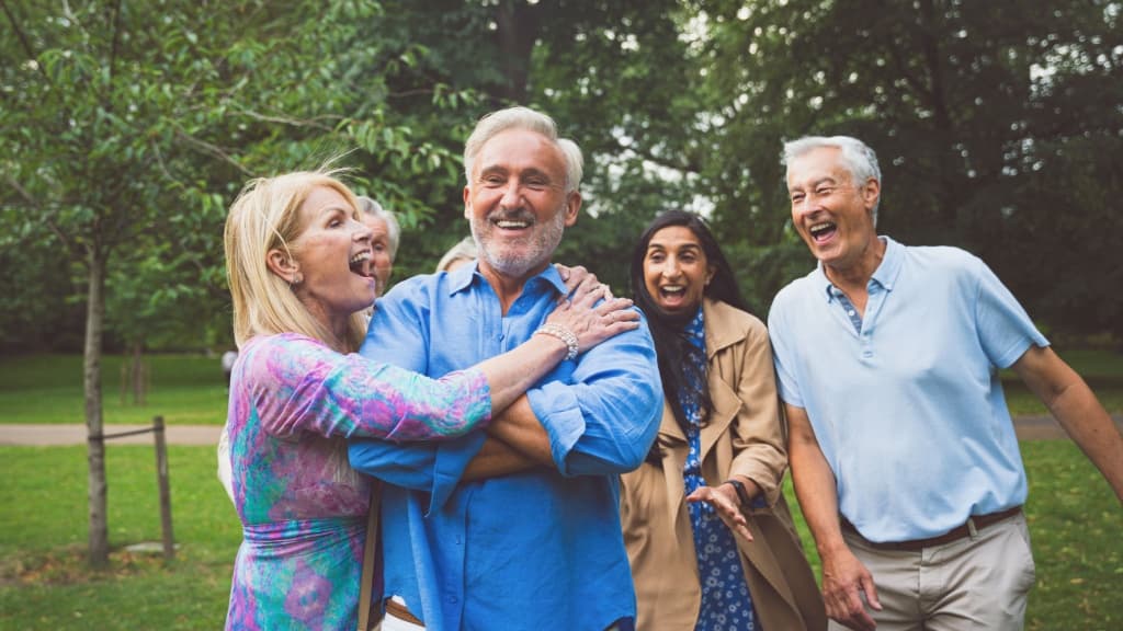 Group of senior friends laughing.