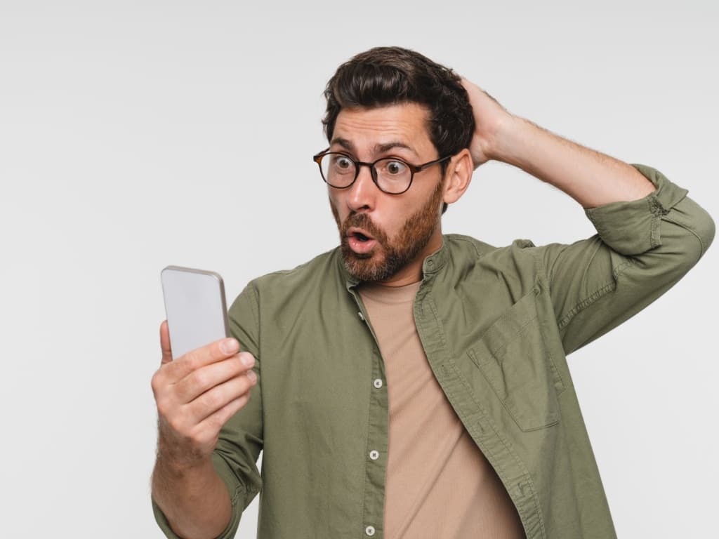Man shocked looking at his phone
