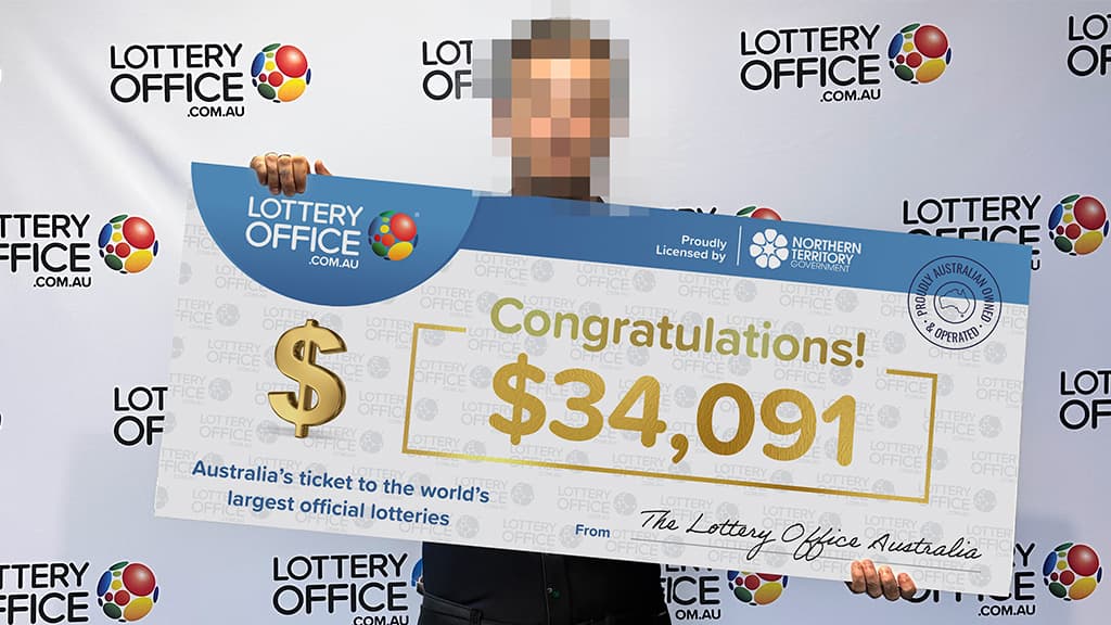 Winner holding giant cheque.