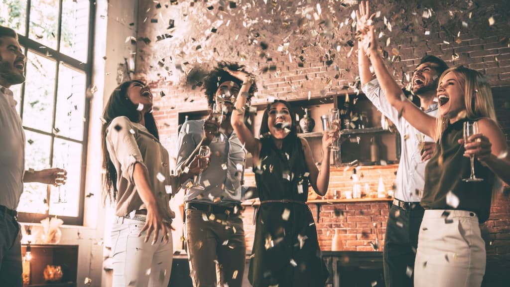Group of happy young people celebrating.