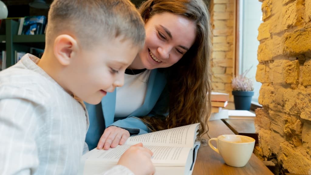 Woman reading with a young child.