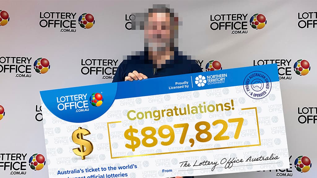Winner holding a big cheque.