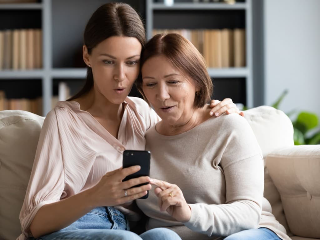 Women looking at a phone.