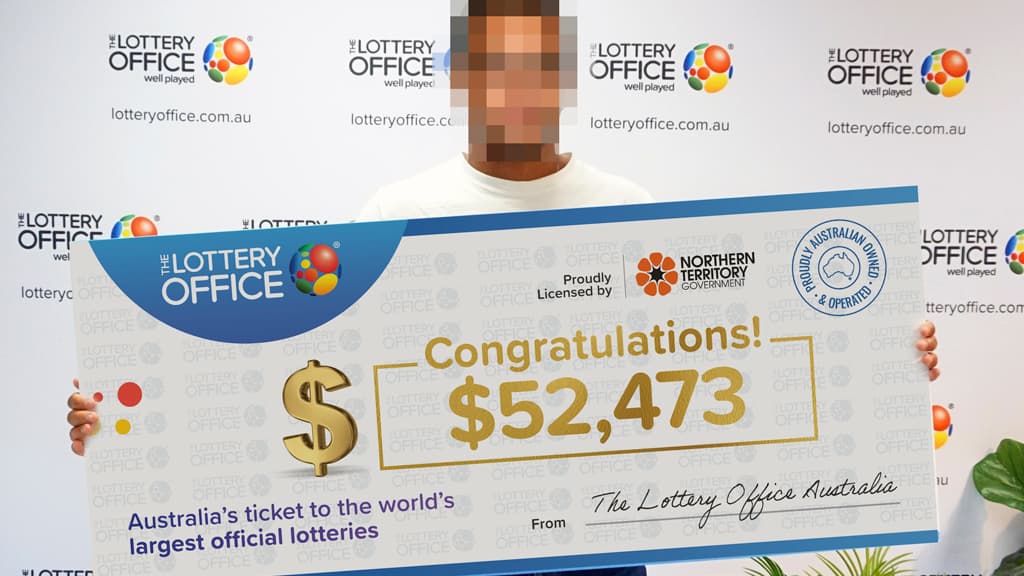 Man holding winning cheque.