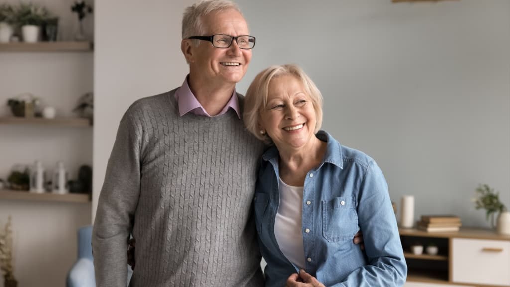 Smiling mature couple staring into the distance.
